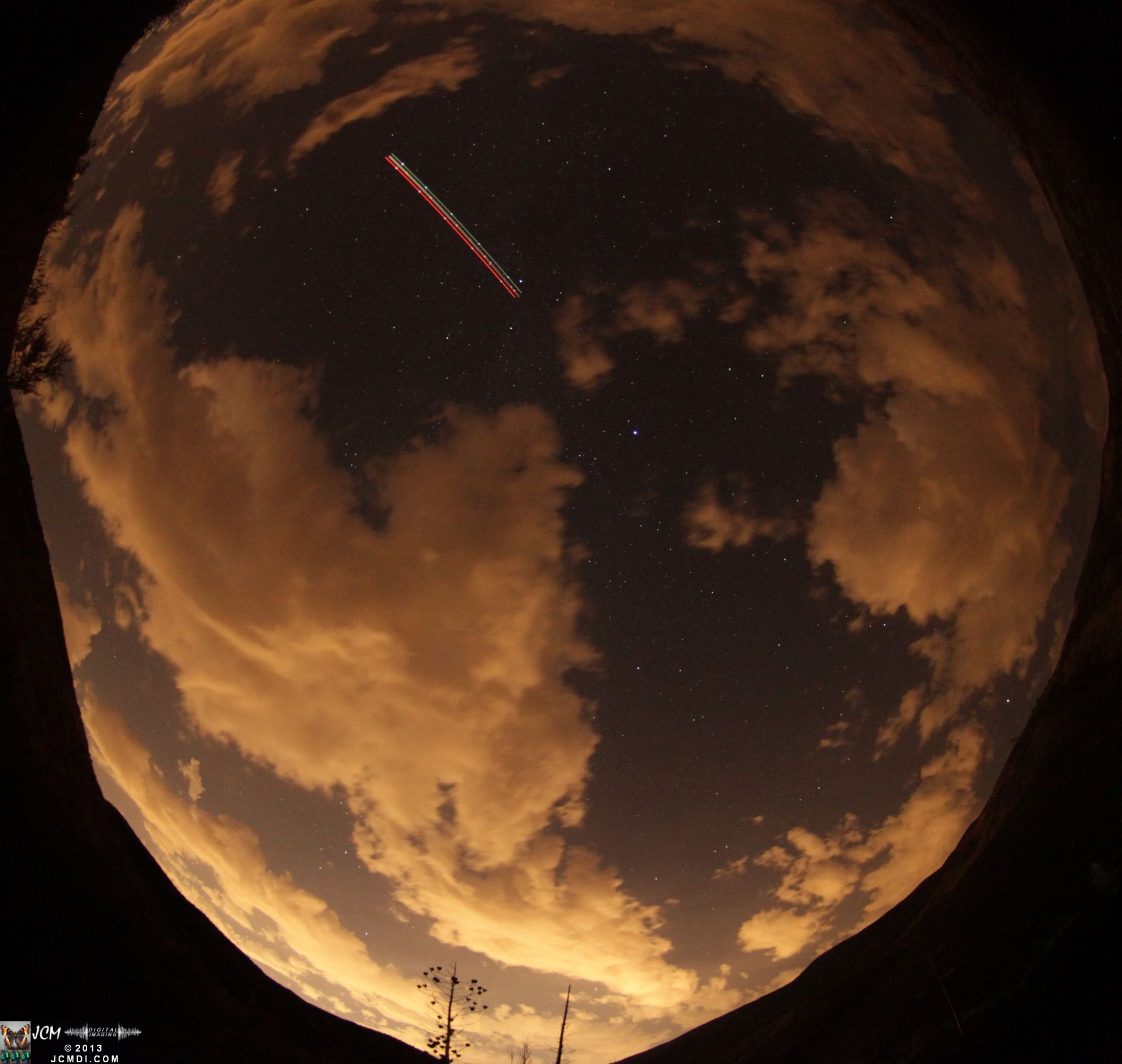 Fisheye view of stars and clouds at night